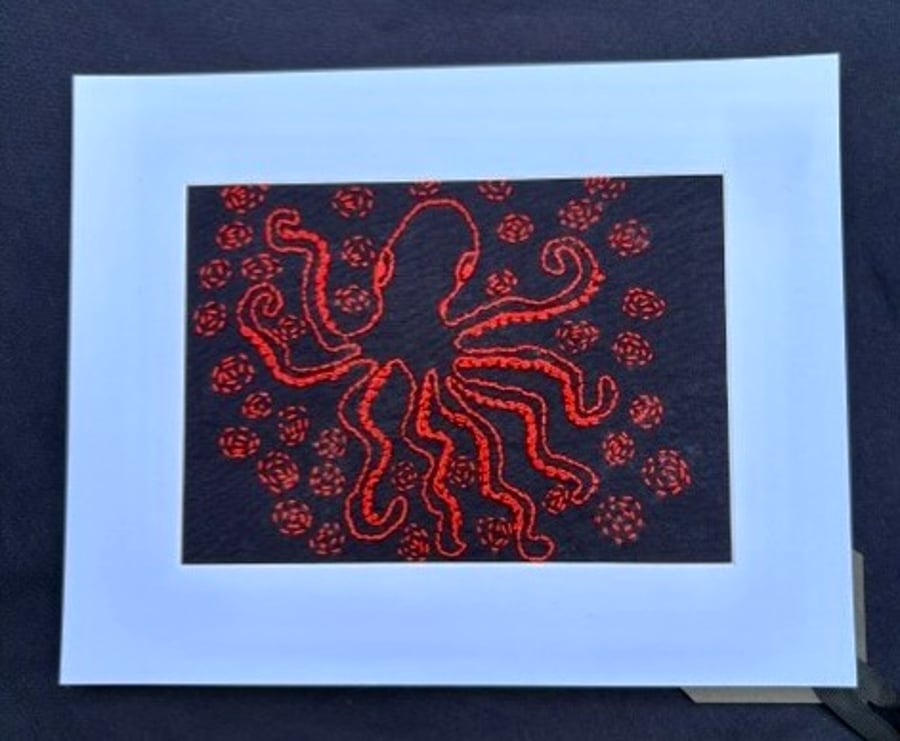 Hand embroidered octopus picture.
