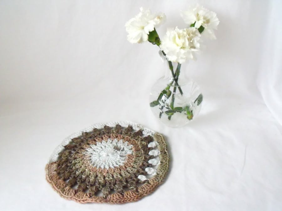 neutral coloured crocheted doily, crocheted mandala using variegated yarn