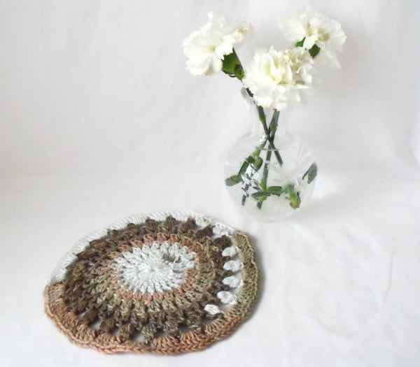 neutral coloured crocheted doily, crocheted mandala using variegated yarn