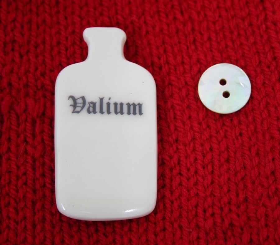Small porcelain bottle brooch