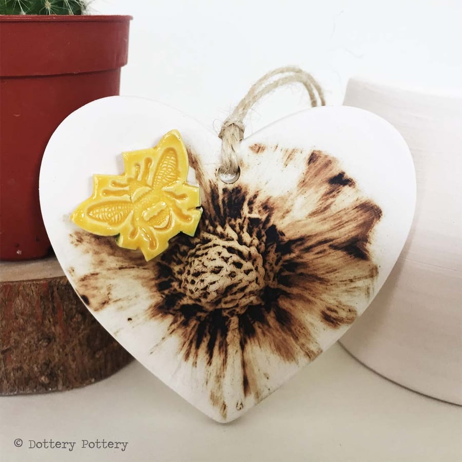 Pottery heart decoration with natural flower design and bee