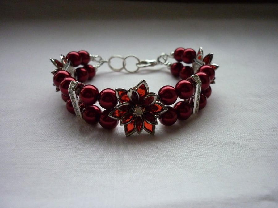 RED AND SILVER FLOWER BRACELET.  975
