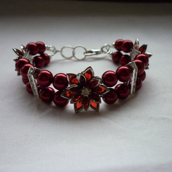 RED AND SILVER FLOWER BRACELET.  975