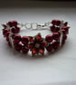 RED AND SILVER FLOWER BRACELET.  975 - Image 1