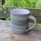 Hand-thrown, stoneware mug in "granite" glaze with white liner ,