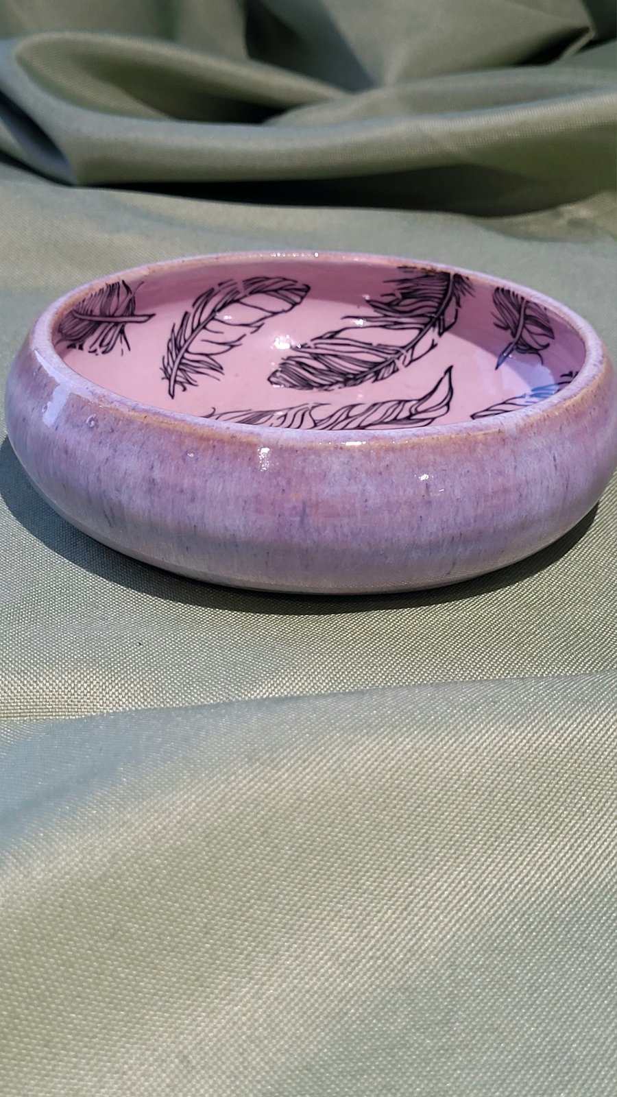 Circular pale pink trinket dish with feather details handmade pottery