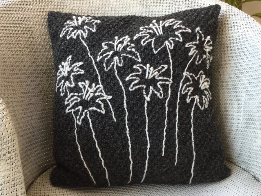 Dark grey hand knitted cushion with embroidered nigella flower heads