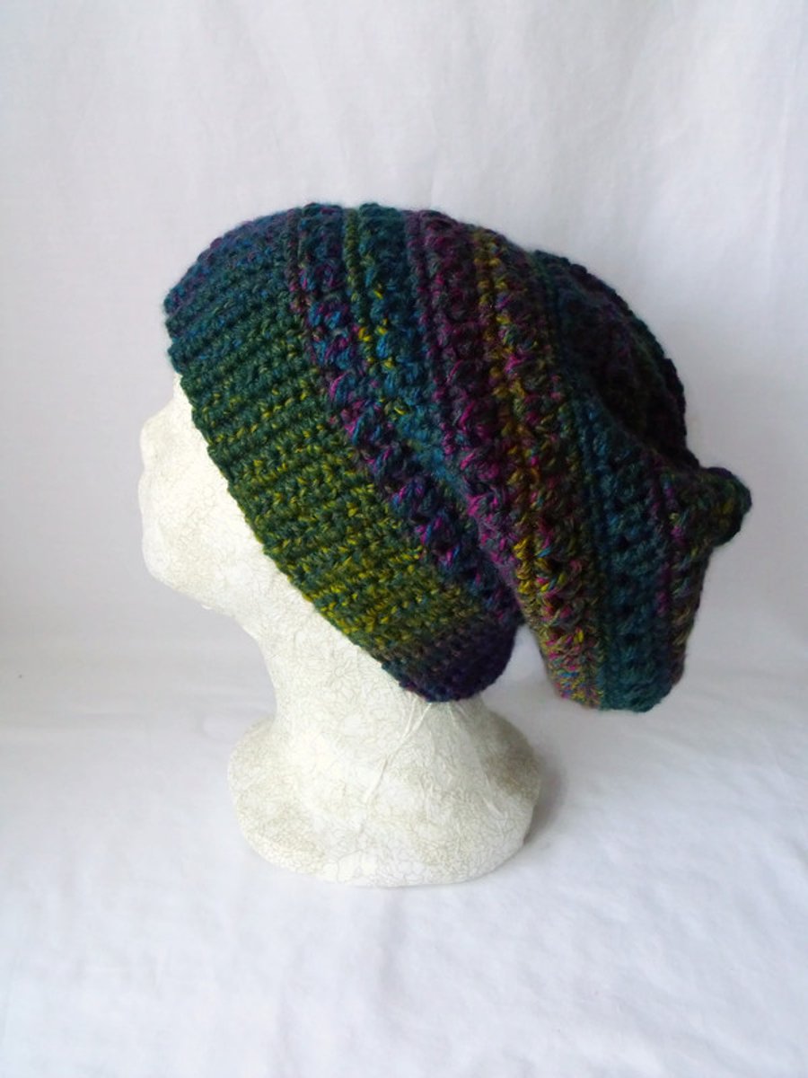 green crocheted slouchie beanie hat with criss cross stitches