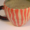 Wheel thrown handpainted stripe animal design espresso mug.