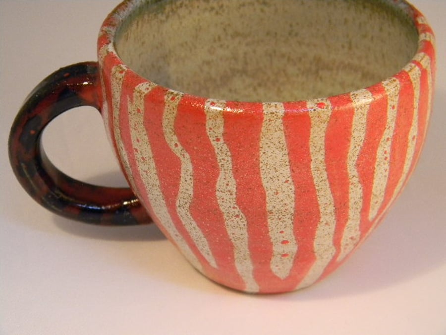 Wheel thrown handpainted stripe animal design espresso mug.