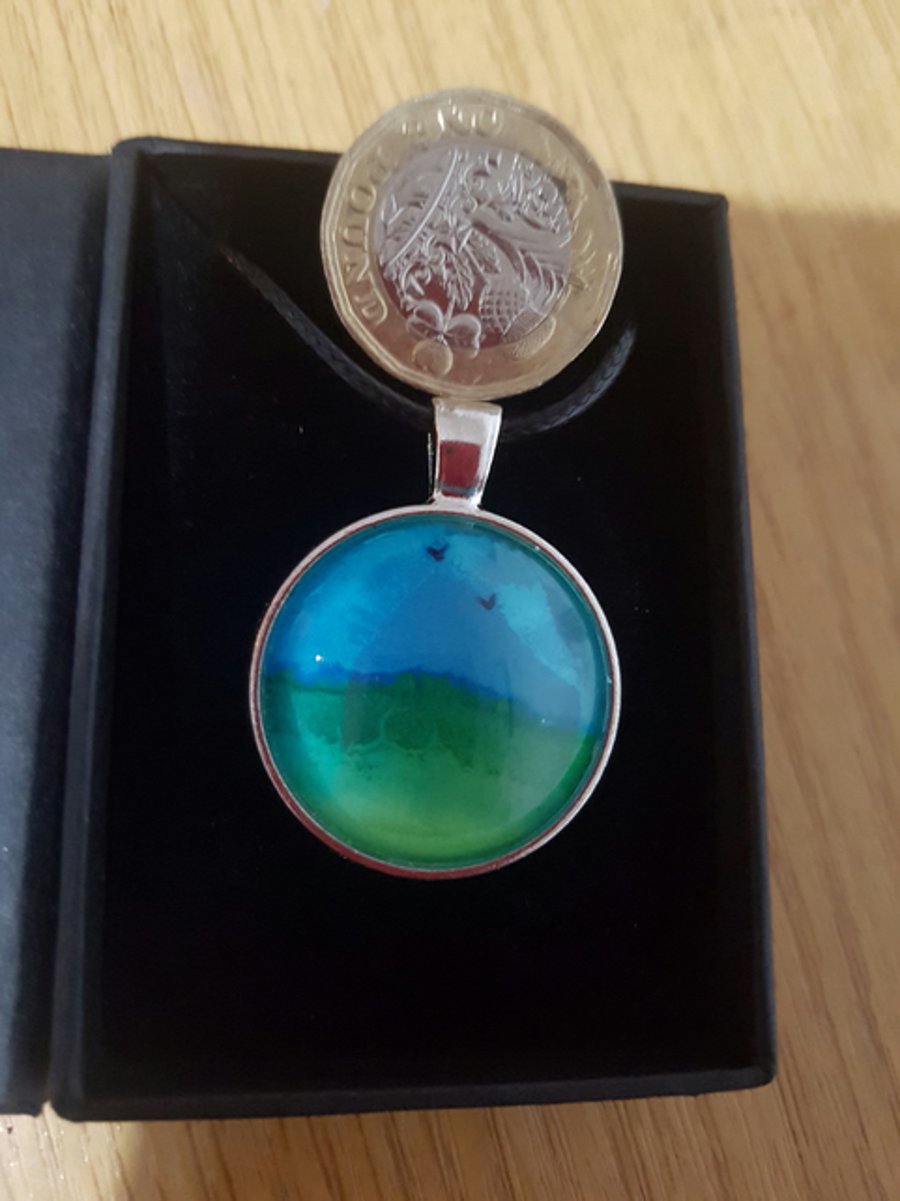 Land and sky with birds pendant.