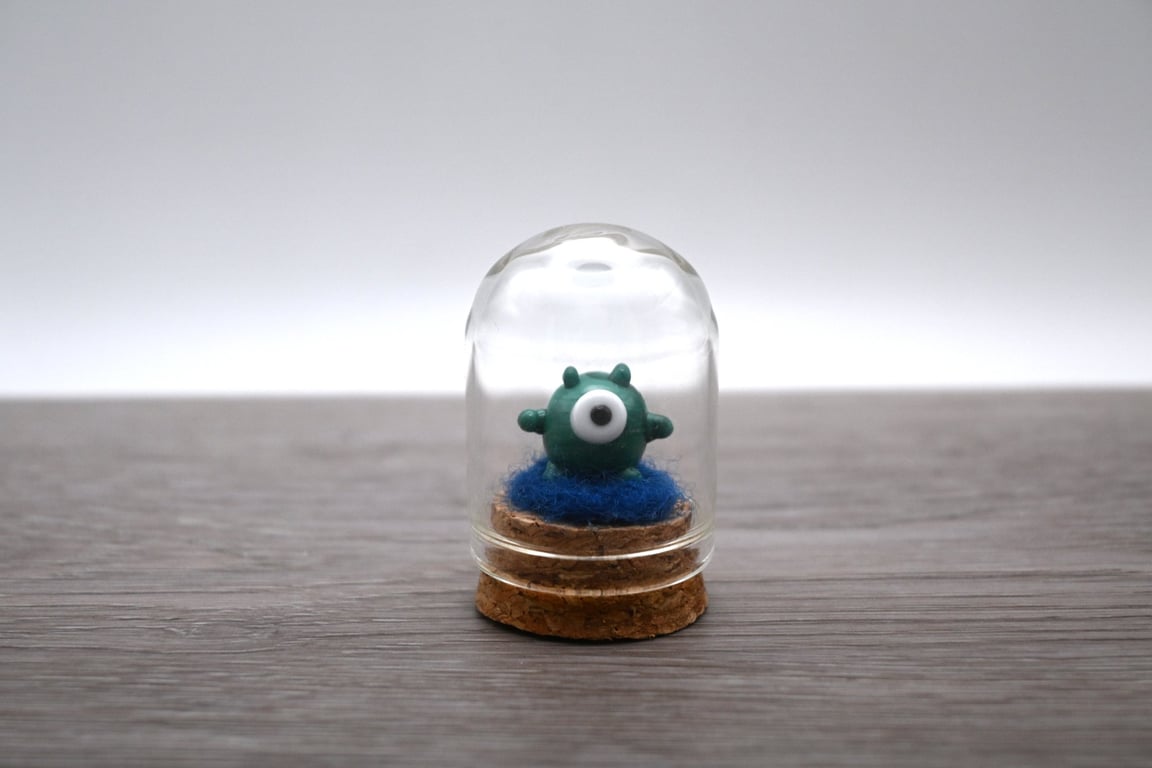 small glass alien figure