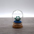 small glass alien figure