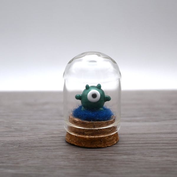 small glass alien figure