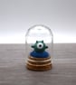 small glass alien figure