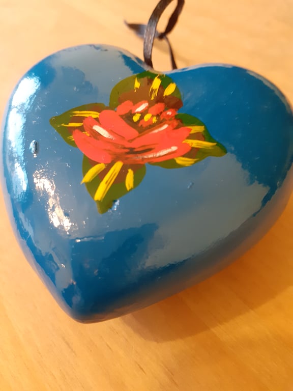 Bright blue heart shaped bauble with canal art style roses