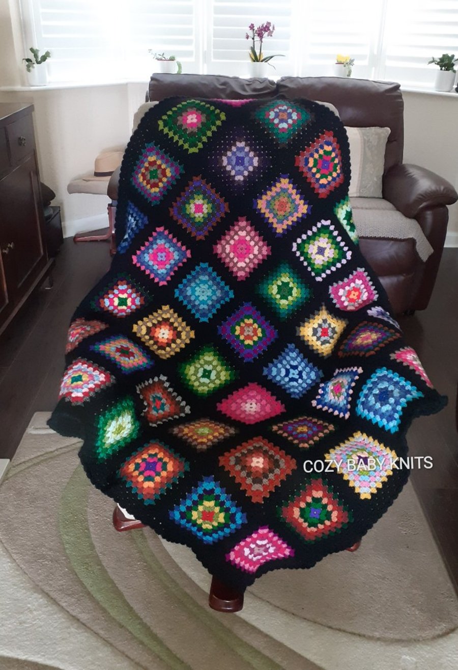 THROW, LAP BLANKET MADE OF GRANNY SQUARES WITH A BLACK BORDER