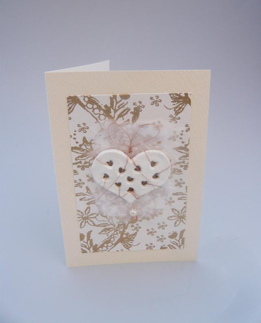 Wedding card with large white heart punched with hearts