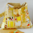 Pyramid shaped cross body shoulder bag in golden yellow