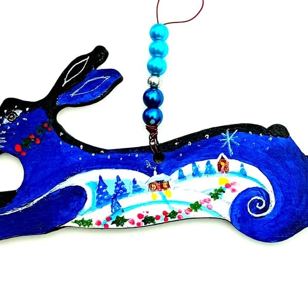 The Christmas hare with snow and holly
