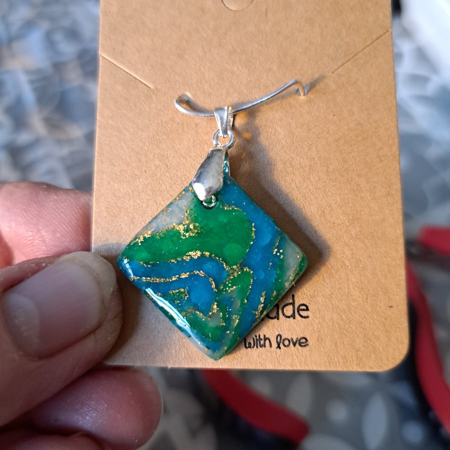 Dark green, blue, white and gold flecked square (hung at an angle) pendant