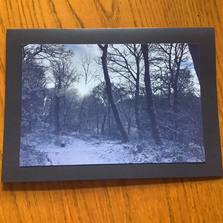 Handmade photo card of a snowy scene with a winter sun through trees.