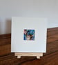 Mounted Resting Whimsical Hare Rabbit with Blue Wildflowers Watercolour Print - Image 1