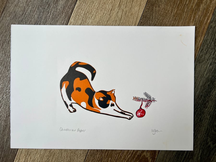 Christmas cat with bauble reduction lino print 