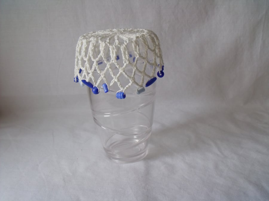 vintage style crocheted beaded doily jug cover to repel bugs when outdoors