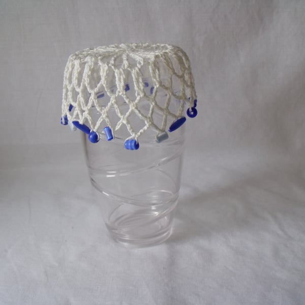 vintage style crocheted beaded doily jug cover to repel bugs when outdoors