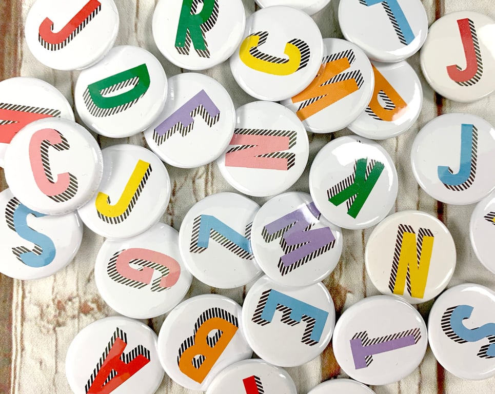 Alphabet pin badges. Word lover. Letter Button rainbow of colours