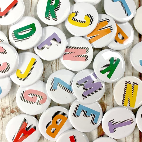 Alphabet pin badges. Word lover. Letter Button rainbow of colours