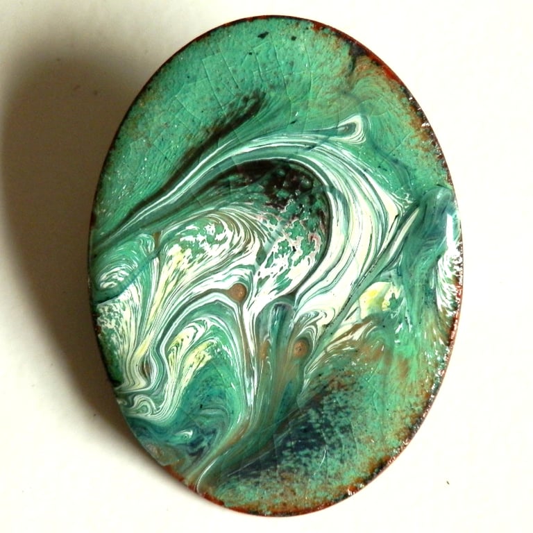 grey and white on green over clear - brooch