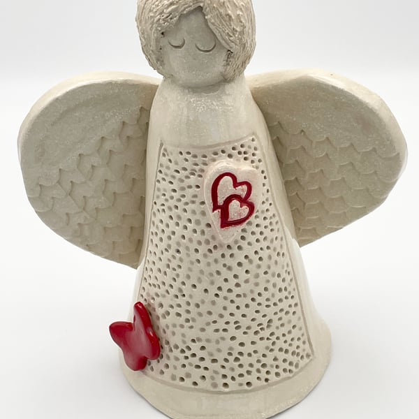Angel sculpture with hearts and butterfly 