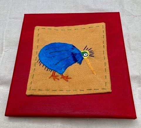 Colourful bird hand embroidered picture.