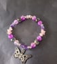 Elasticated pastel goth beaded bracelet with skull and butterfly charm - Image 2