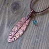 Rustic copper patterned feather pendant