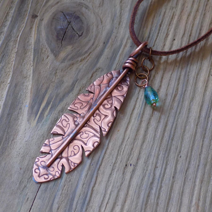 Rustic copper patterned feather pendant
