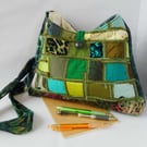 Pyramid shaped shoulder bag in rich greens