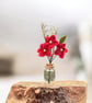 Trio of miniature felted flowers in glass bottle vase (red)