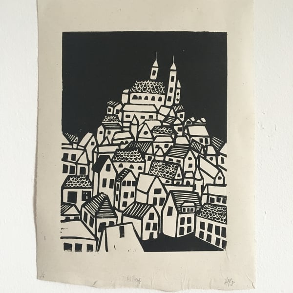 Hilltop, linocut print of a hill top town on handmade paper.