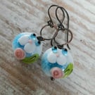 Copper earrings with blue white lampwork cat beads