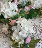 Handmade floral multi coloured, multi flowered garland table decoration. - Image 4