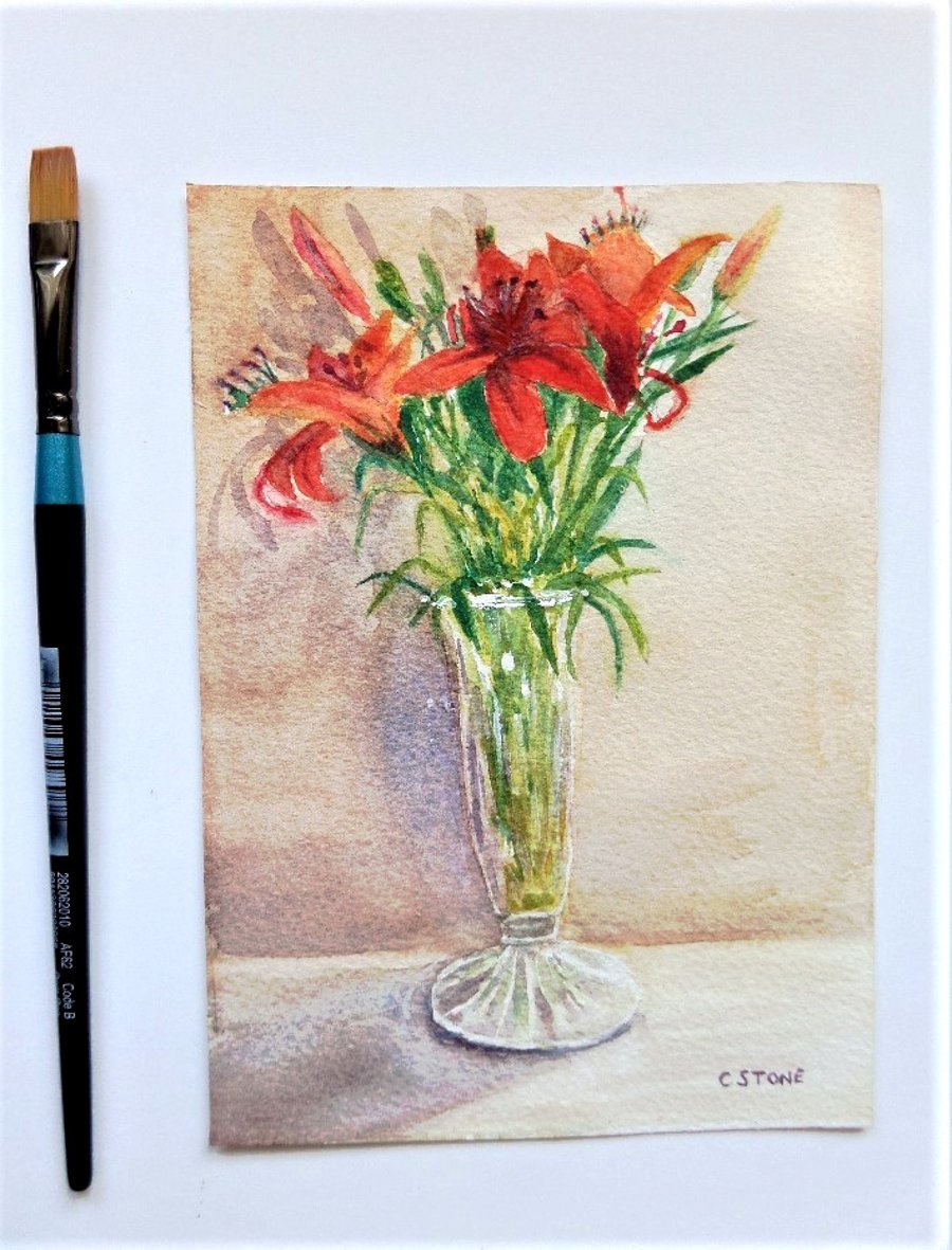 Small watercolour still life painting of red lilies arranged in glass vase