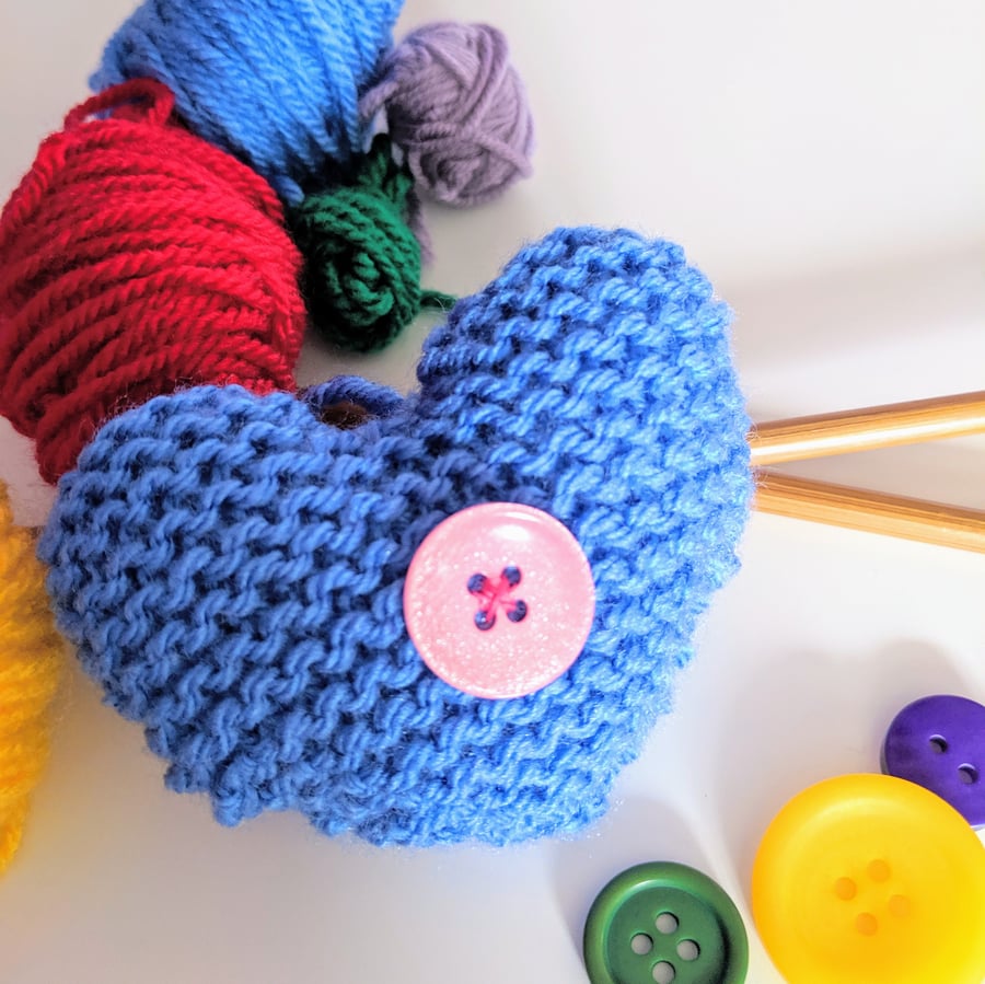 Hand-knitted pastel blue button heart