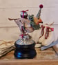 Heirloom Robin with pudding on a wind up musical textile art soft sculpture.