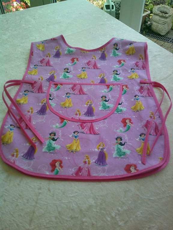 Child's Tabard Apron with Princesses on a Pink Background