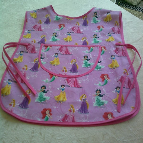 Child's Tabard Apron with Princesses on a Pink Background