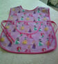 Child's Tabard Apron with Princesses on a Pink Background