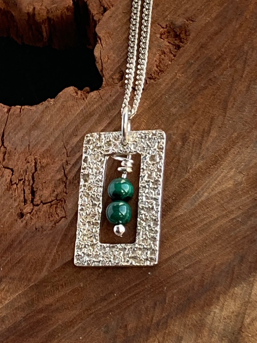 Silver framed pendants with malachite beads